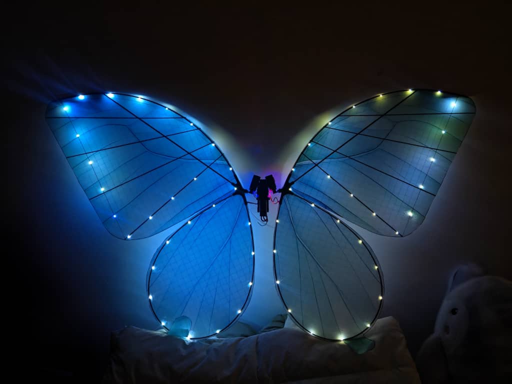 Glowing remote-controlled mechanical butterfly at a luxurious event